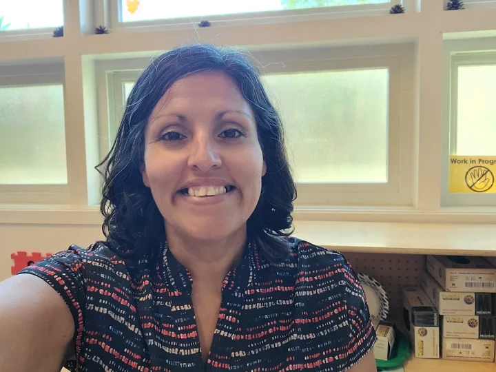 Vanessa Manrique, Director of Growing FootPrints, smiling in the school office.